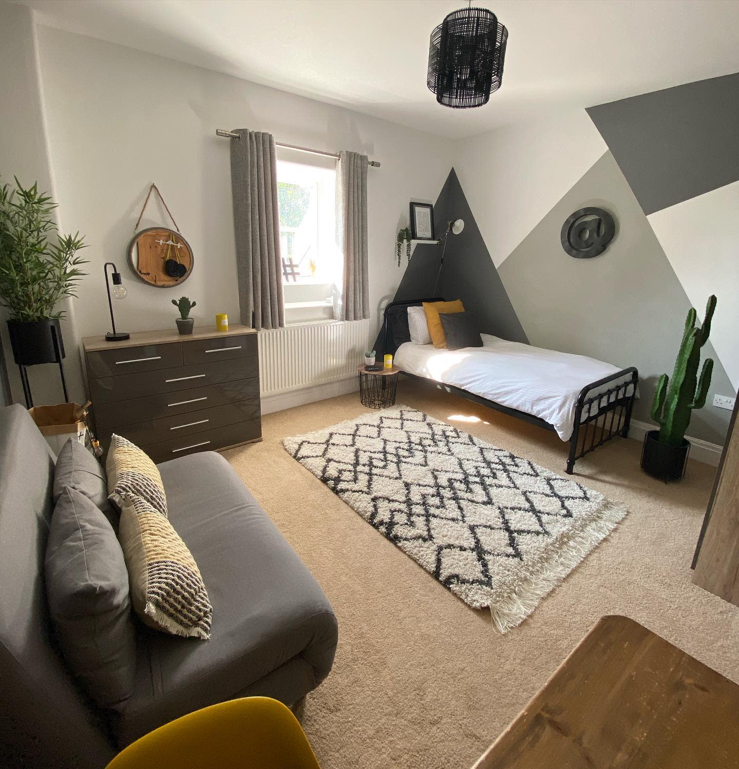 abstract wall shapes painted in shades of gray single bedroom 